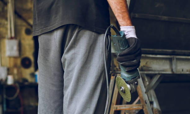 istock Indian or Pakistani worker holding disc cutter machine in hand at workshop 1412424787