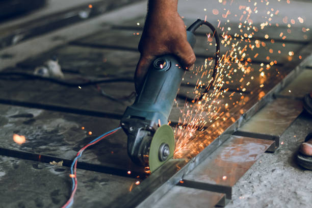 istock Worker cutting metal frame with hand cutter, disk cutter with sparks 1412426811