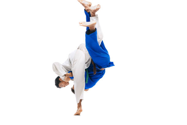 istock Studio shot of two men, professional judo athletes training, practising throws isolated over white background 1412427936