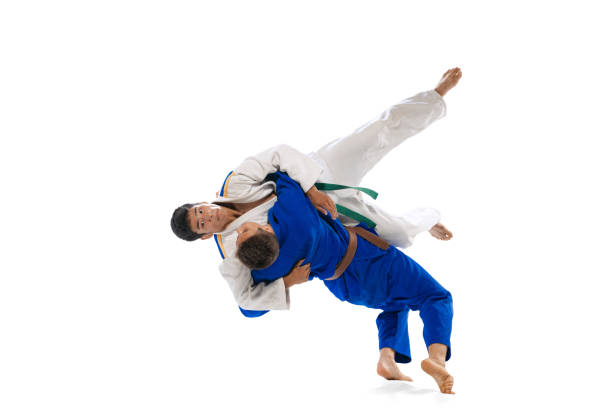 istock Studio shot of two men, professional judo athletes training isolated over white background. Throwing exercises 1412427944