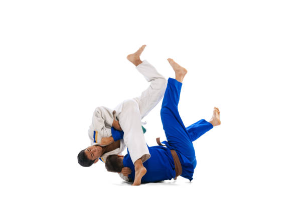 istock Studio shot of two men, professional judo athletes training isolated over white background. Self-defense exercises 1412427969