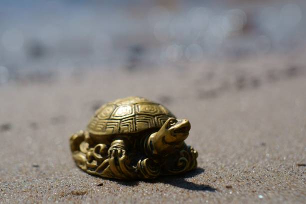 istock A metal turtle on the riverbank. 1412428218