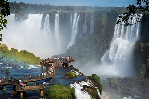 Tourists exploring the Brazilian side of Iguazu Falls, on the border of Brazil and Argentina.