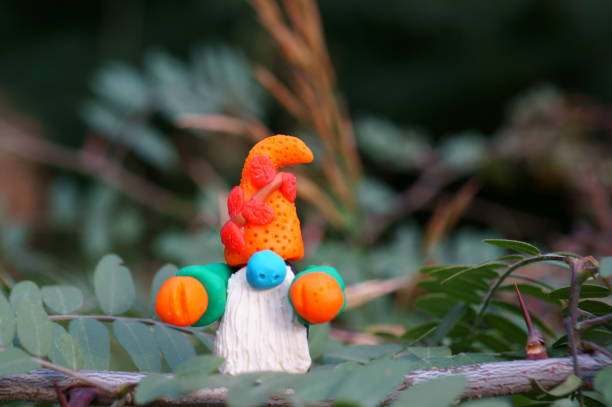 istock A gnome figurine on a tree branch. 1412429054