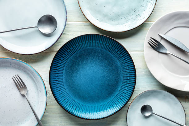 istock Modern tableware set with cutlery and a vibrant blue plate, overhead shot 1412429293
