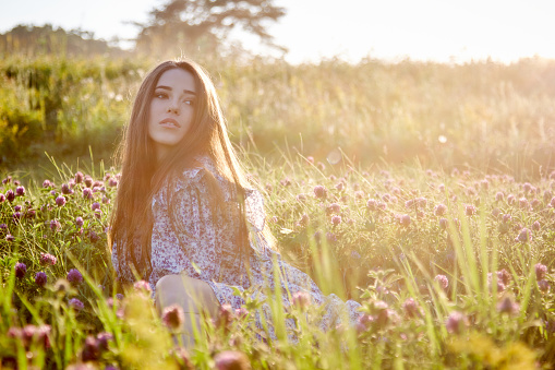 young beautiful girl with a bouquet of flowers in nature