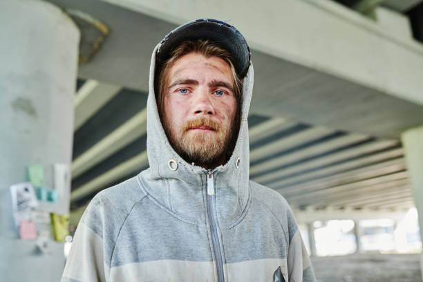 istock Poor homeless young man outdoors 1412431801