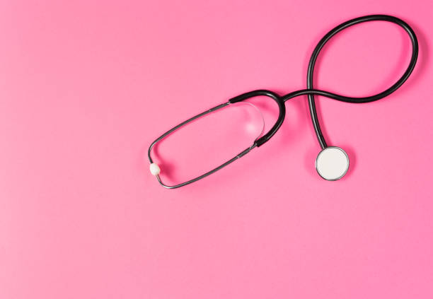istock Top view of black stethoscope on the pink background. 1412432064