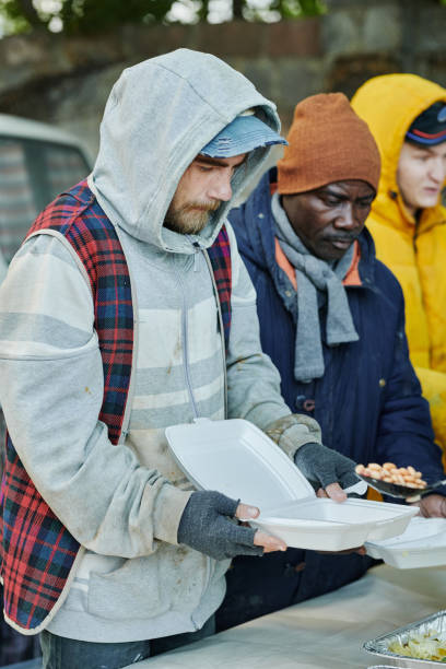 istock Homeless people feeding by volunteers 1412432398