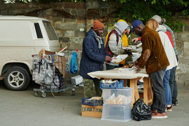 istock Homeless people getting food from volunteers 1412433149