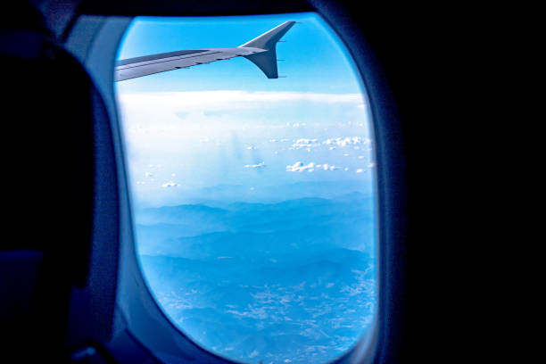 istock View of blue cloudy sky from airplane window 1412434263