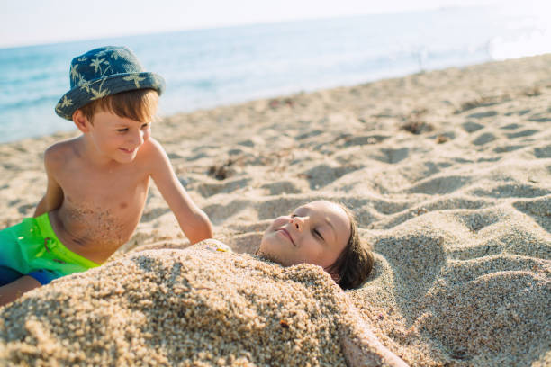 Little girl and boy enjoying beach holidays
