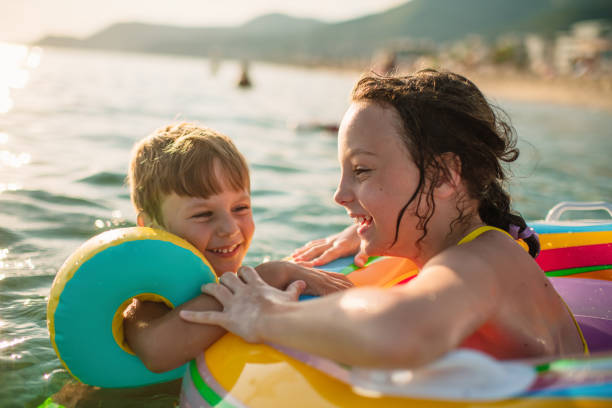 istock Children having fun in the sea on summer vacations 1412435604