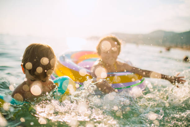 istock Children having fun in the sea on summer vacations 1412435607