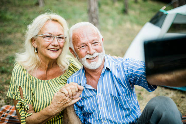 istock Senior Couple On Autumn Camping Trip having video call 1412436828