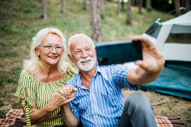 istock Senior Couple On Autumn Camping Trip having video call 1412436930