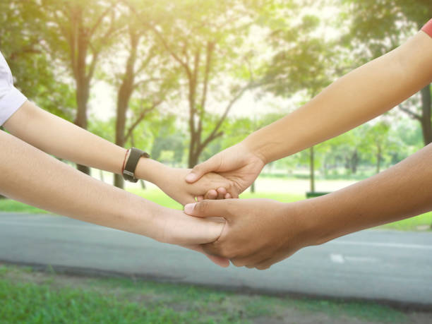 istock Image of a couple holding hands in a park 1412438581