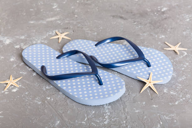 istock Beach accessories. Flip flops and starfish on colored background. Top view Mock up with copy space 1412439793