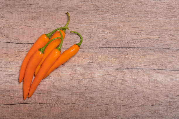 istock orange capsicum on wooden background 1412439935