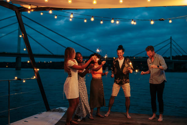 istock Friends celebrate with sparklers and drinks on boat 1412445585