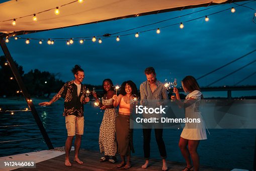 istock Multiracial smiling friends enjoying on the boat 1412446063