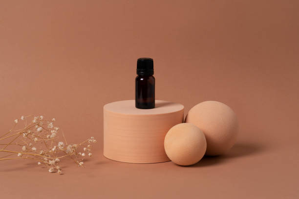 istock A glass bottle with aromatic oil or serum placed on geometric figured 1412447785
