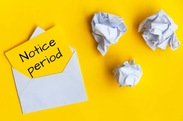 istock Notice period text on yellow notepad in an envelope. 1412449832