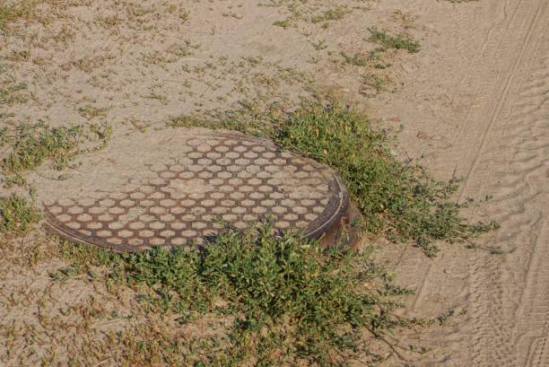 istock one brown iron sewer hatch lies on gray ground 1412453631