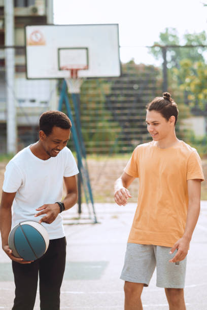 istock Friends playing basketball 1412456016