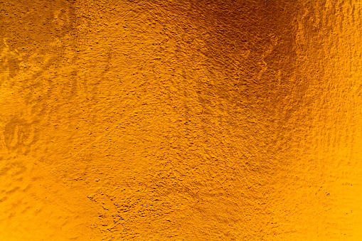 Golden wall plaster glitter texture background