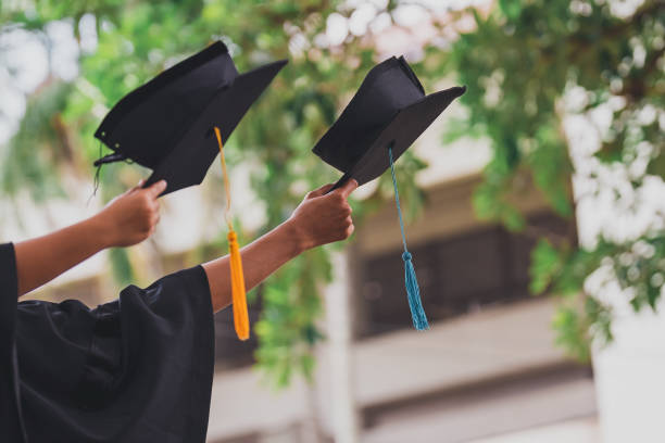 istock Black hat of the graduates floating in the sky. 1412457691