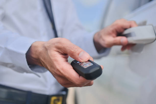 istock Close up hand holding key opening car door 1412457830