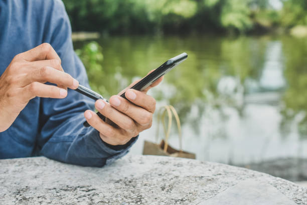 istock Close up man using mobile smart phone ,business, people, cellphone, touchscreen, touchphone, cell, businessman, smartphone, phone, telephone, lifestyle, technology, device 1412458748