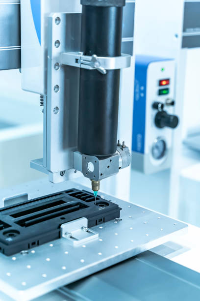 istock High precision and technology of nozzle device and needle of automatic glue dispenser machine (glue injection) at factory 1412459598