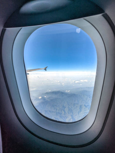 istock Clouds and sky as seen through window of an aircraft 1412459652