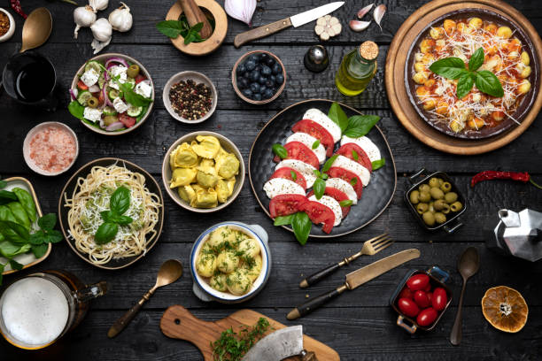 istock Big dinner table with Italian food, pizzas and pastas 1412464596