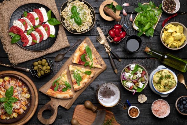 istock Big dinner table with Italian food, pizzas and pastas 1412464746