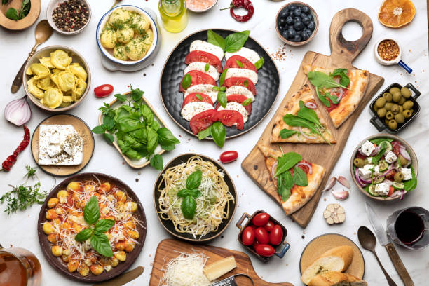 istock Big dinner table with Italian food, pizzas and pastas 1412465080