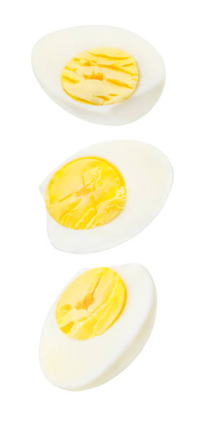 Boiled eggs, cut, three pieces,  falling, hanging, flying, soaring, isolated on white background with clipping path.