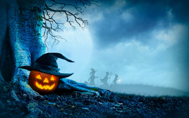 istock Children Trick Or Treating On Halloween Night Pass By Jack O'Lantern 1412467589
