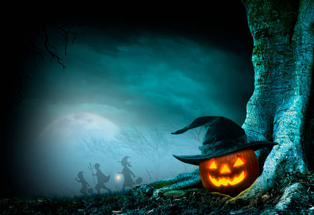 istock Children Trick Or Treating On Halloween Night Pass By Jack O'Lantern 1412467607
