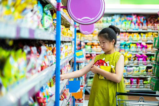 Asian cute little girl shopping in supermarket