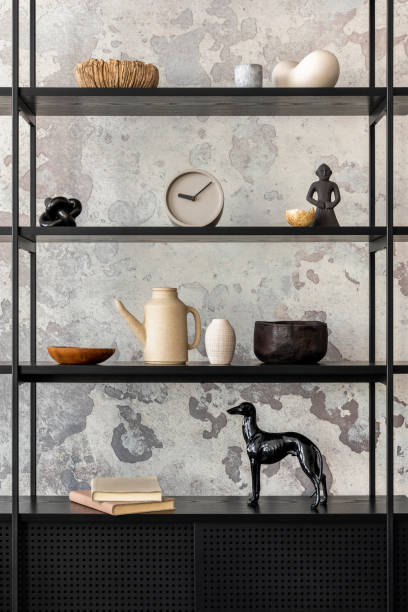 istock Creative composition of wabi sabi interior with black rack with  personal accessories. Grey concrete wall. Home decor. Template. 1412468704