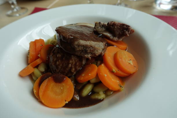 istock Lamb stew served with beans and carrots 1412469054