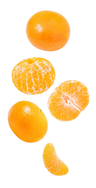 istock Tangerines, whole and peeled slices  falling, hanging, flying, soaring isolated on white background with clipping path. 1412469477