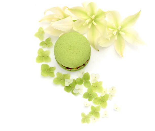 istock Green macaron and flowers on a white background. 1412471383