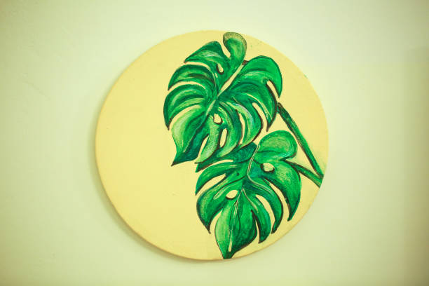 Leaves painted on a round canvas stock photo