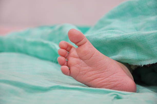 this is an indoor shot of new born baby leg..