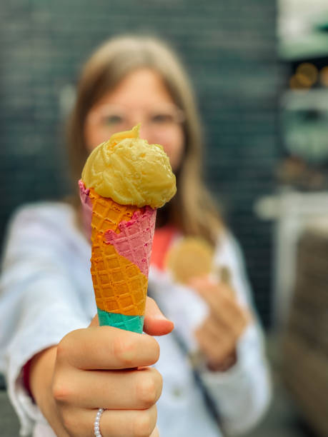 istock Girl holding ice cream with rainbow cone 1412473037