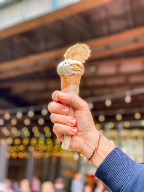 istock Hand holding ice cream at London’s Borough market 1412473082